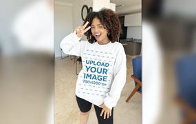 室内背景卷发模特长袖运动衫样机图 Gildan Sweatshirt Mockup Featuring a Curly-Haired